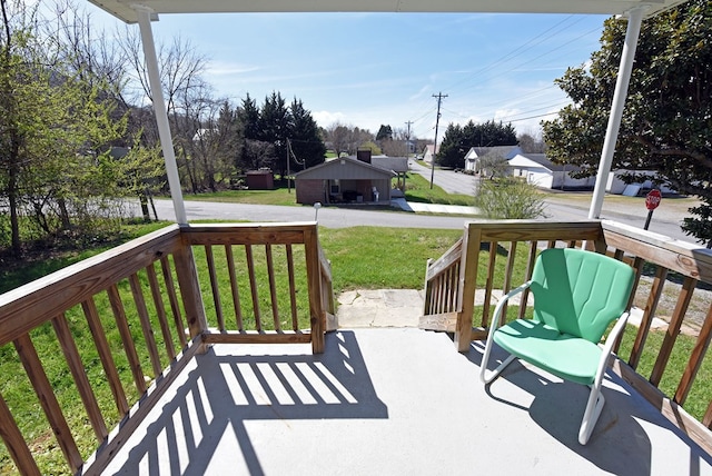 deck with a lawn and a porch