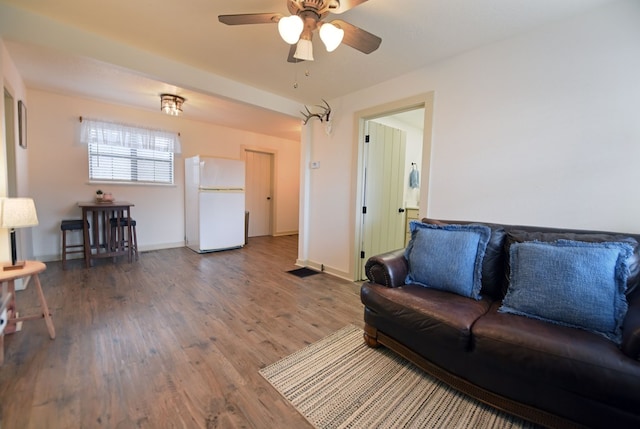 living room featuring wood-type flooring and ceiling fan