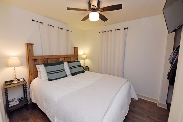 bedroom featuring ceiling fan and dark wood-type flooring