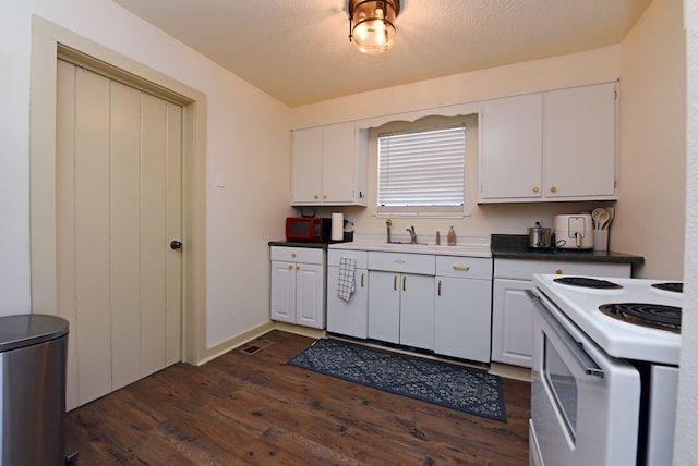 kitchen featuring white cabinetry, electric range, and dark wood-type flooring