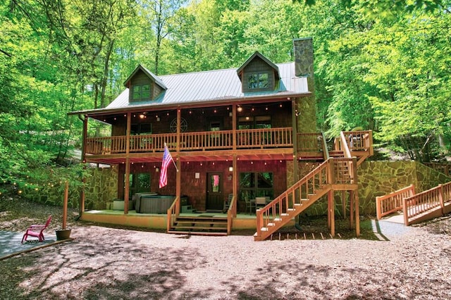 56 Laurel Dr, Blue Ridge, GA 30513 - chalet / cabin featuring a chimney, a wooden deck, a patio, metal roof, and a wooded view