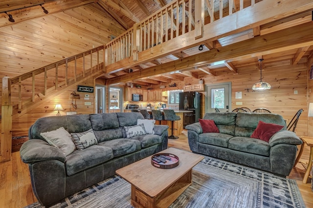 56 Laurel Dr, Blue Ridge, GA 30513 - living area with wood walls, light wood-type flooring, beamed ceiling, wood ceiling, and stairway