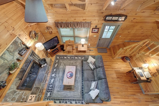 56 Laurel Dr, Blue Ridge, GA 30513 - living area with wooden walls, wood finished floors, beamed ceiling, and a fireplace