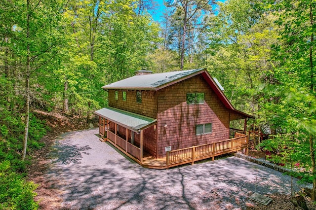 56 Laurel Dr, Blue Ridge, GA 30513 - view of property exterior featuring metal roof, a wooded view, and a deck