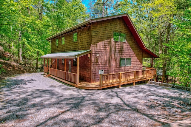 56 Laurel Dr, Blue Ridge, GA 30513 - view of home's exterior with metal roof, a deck, and a wooded view