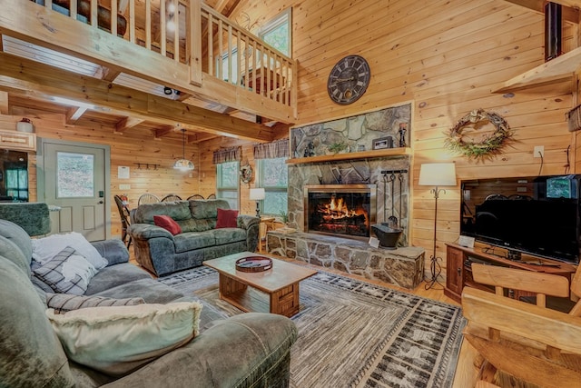 56 Laurel Dr, Blue Ridge, GA 30513 - living area featuring wooden walls, a towering ceiling, a stone fireplace, and wood finished floors