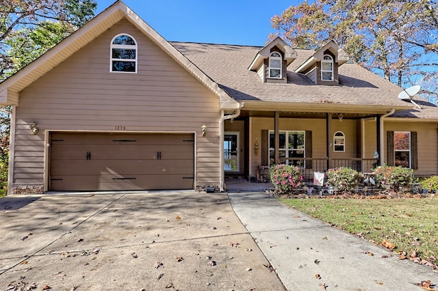 view of front of home with a porch and a garage