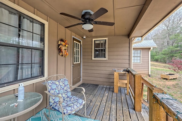 wooden terrace featuring ceiling fan