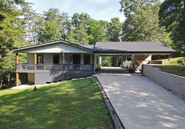 view of front of home featuring covered porch, a front yard, and a carport