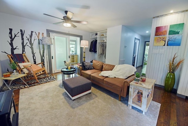 living room with ceiling fan and dark hardwood / wood-style flooring