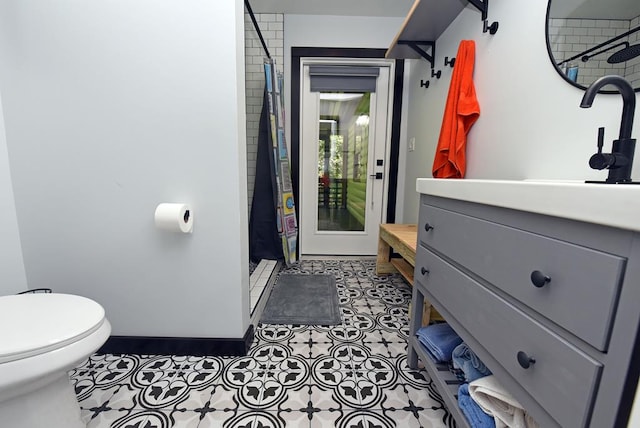 bathroom with tile patterned floors, vanity, toilet, and a shower with curtain