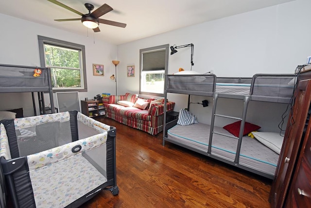 bedroom with ceiling fan and dark wood-type flooring