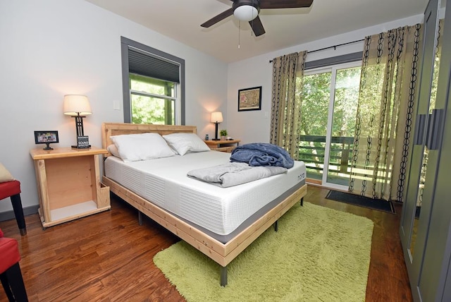 bedroom with ceiling fan, dark hardwood / wood-style floors, and access to outside