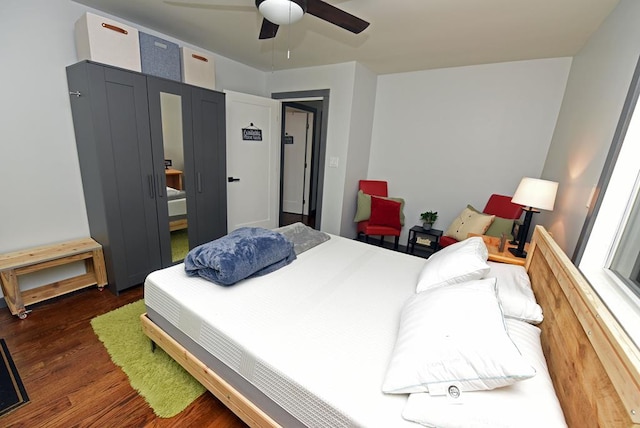 bedroom featuring ceiling fan and dark wood-type flooring