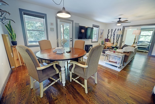 dining room featuring ceiling fan, dark hardwood / wood-style flooring, and a healthy amount of sunlight