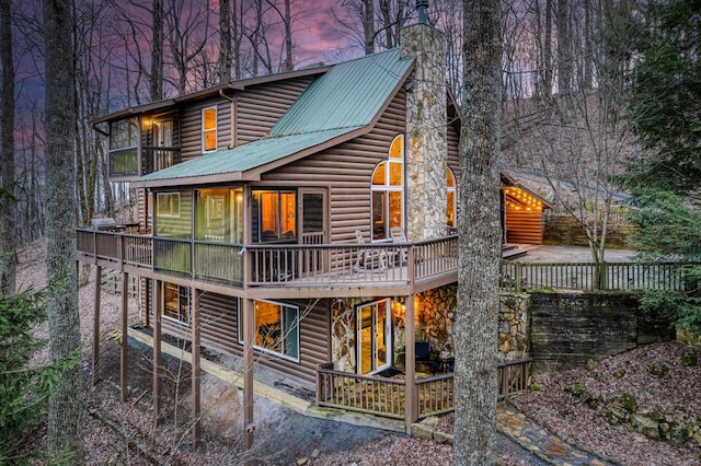 view of back house at dusk