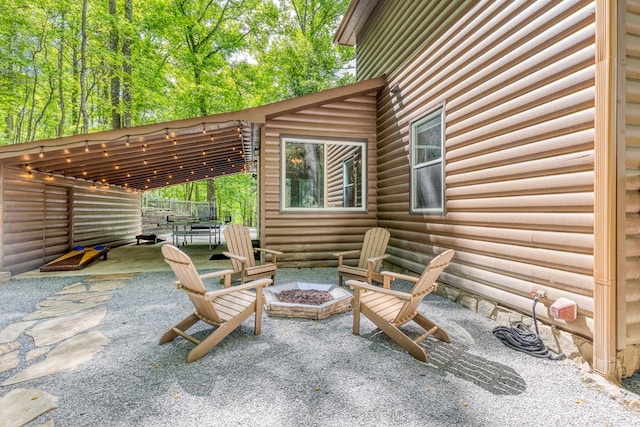 view of patio / terrace featuring an outdoor fire pit