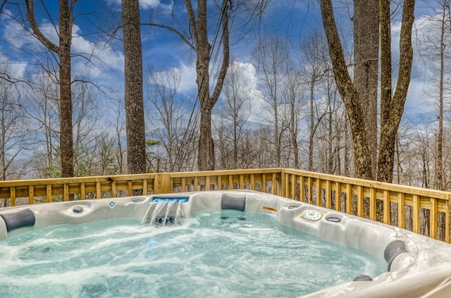 wooden terrace featuring a hot tub