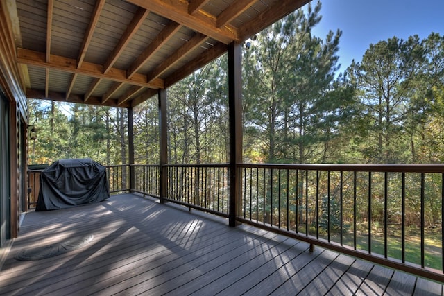 wooden deck with a grill
