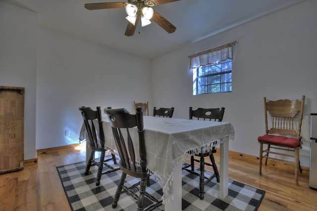 dining area featuring light wood-style flooring and ceiling fan
