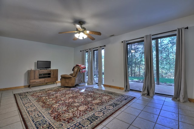 living room with light tile patterned flooring, visible vents, baseboards, and ceiling fan