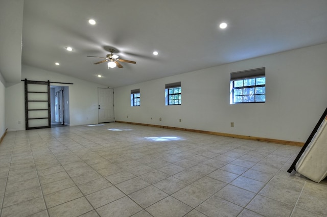 empty room with a ceiling fan, baseboards, recessed lighting, and a barn door