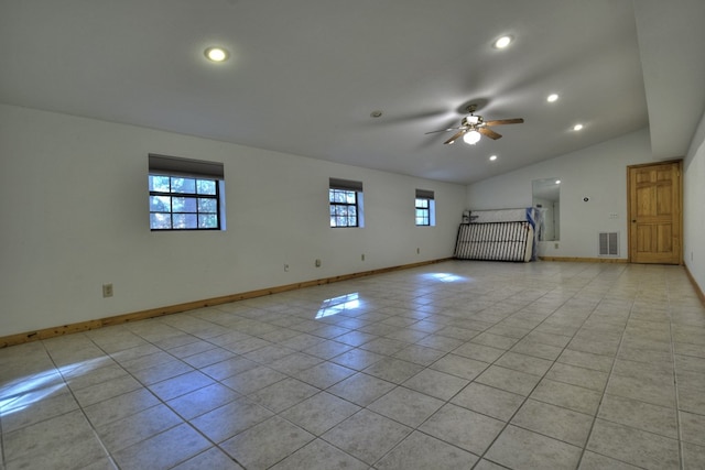 unfurnished living room with a wealth of natural light, lofted ceiling, visible vents, and light tile patterned floors