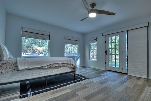 bedroom with ceiling fan, baseboards, access to outside, and wood finished floors
