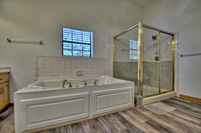 full bathroom with a bath, vanity, wood finished floors, and a stall shower