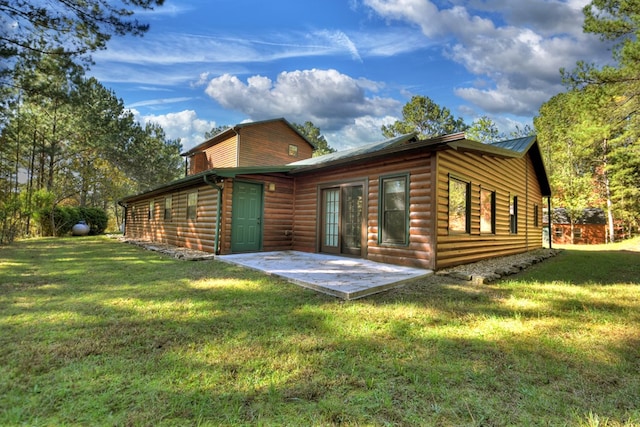 back of property featuring faux log siding, a lawn, and a patio