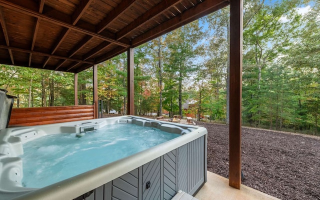 view of swimming pool with a hot tub