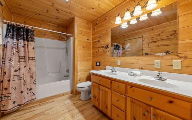 full bathroom with vanity, shower / bath combination with curtain, wooden walls, toilet, and wood ceiling