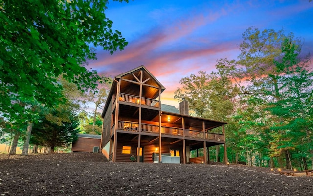 view of back house at dusk