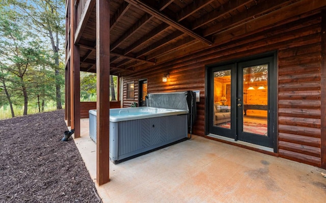 view of patio with french doors and a hot tub