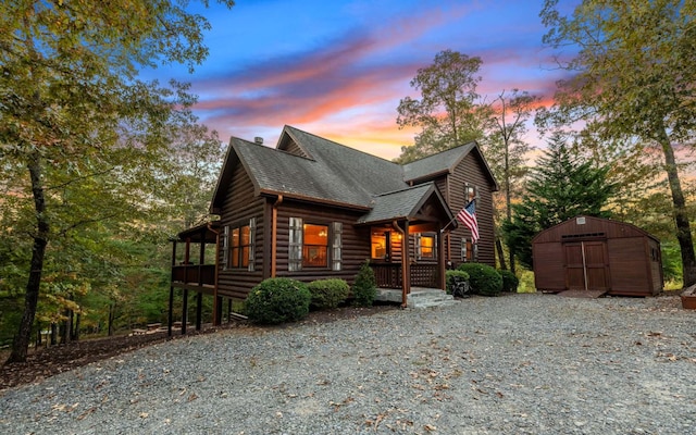 log home featuring a storage shed