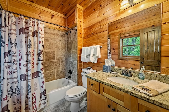 full bath with wooden walls, vanity, shower / bathtub combination with curtain, and toilet