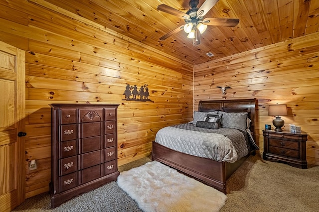 bedroom featuring wood walls, wooden ceiling, and carpet