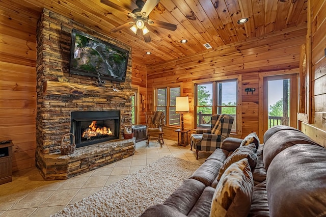 living room featuring wood ceiling, ceiling fan, tile patterned flooring, a fireplace, and recessed lighting
