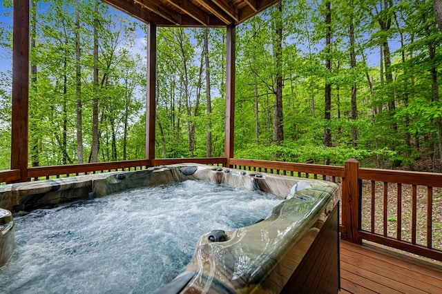 wooden deck with a hot tub