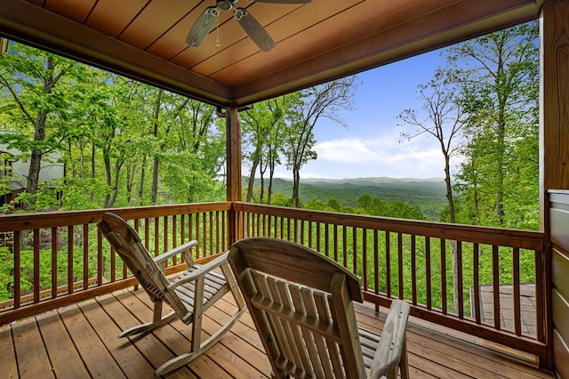 deck with ceiling fan and a mountain view