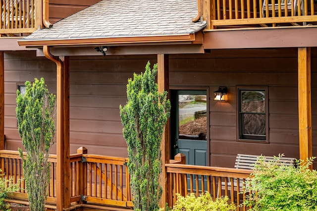 doorway to property with a shingled roof