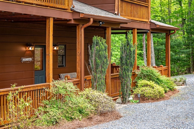 exterior space featuring a shingled roof
