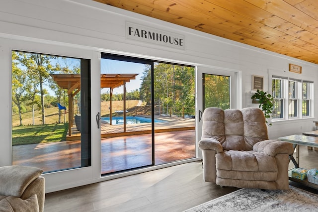 doorway to outside with hardwood / wood-style floors and wood ceiling