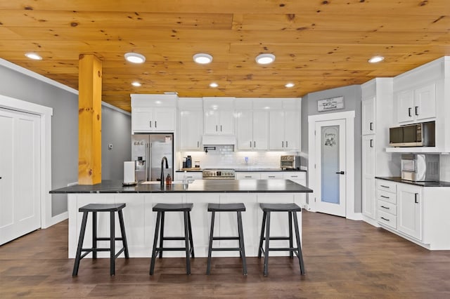 kitchen with wooden ceiling, dark hardwood / wood-style flooring, a kitchen bar, and white cabinets