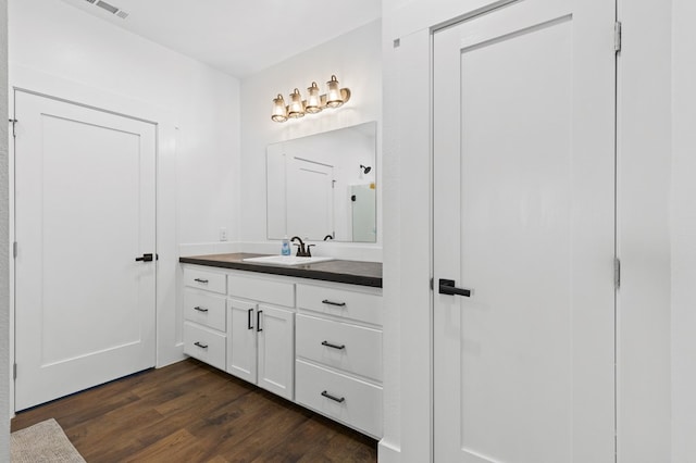 bathroom with vanity and hardwood / wood-style flooring