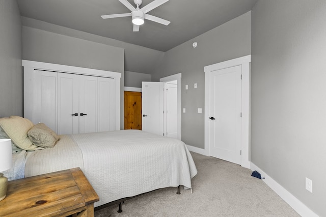 bedroom with vaulted ceiling, carpet floors, a closet, and ceiling fan