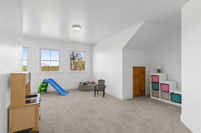 game room featuring lofted ceiling and light colored carpet