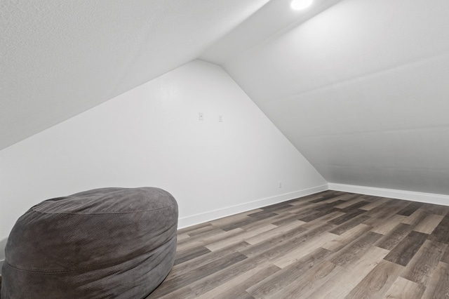 bonus room featuring dark hardwood / wood-style flooring and vaulted ceiling