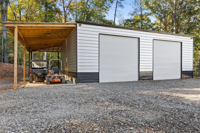 view of outdoor structure with a carport and a garage