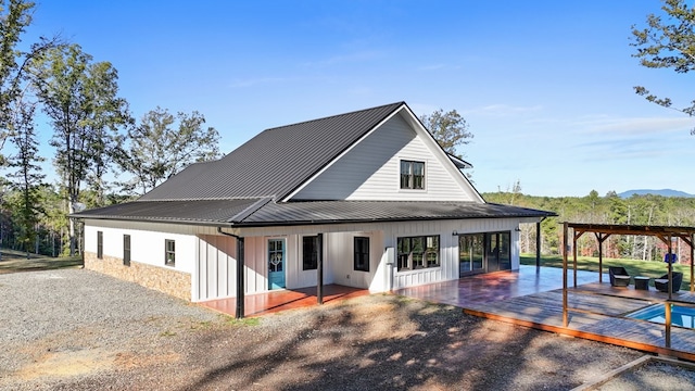 rear view of property with a wooden deck